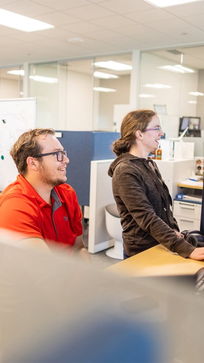 Two office employees working at computers
