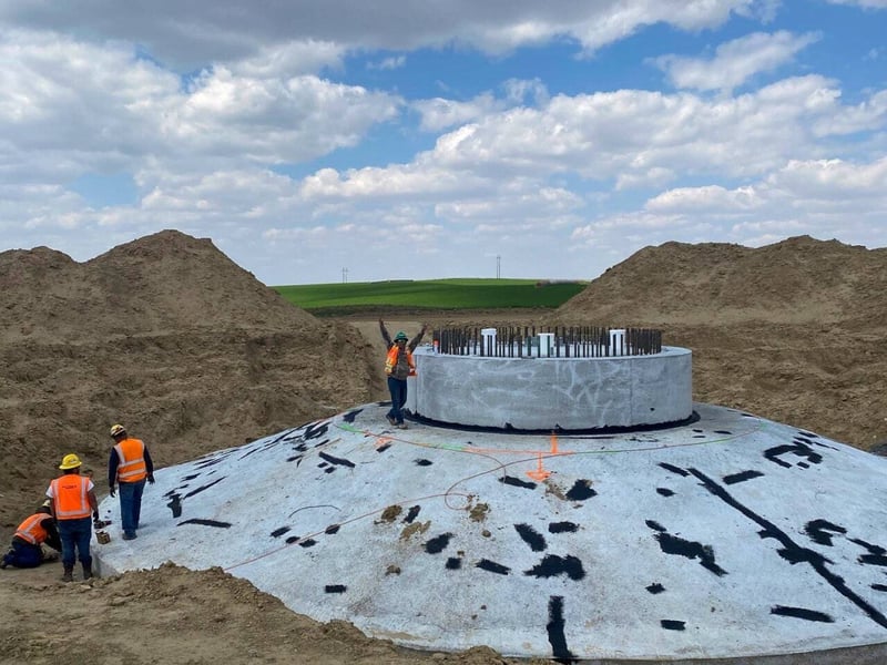 employees working on the construction of a wind turbine concrete foundation