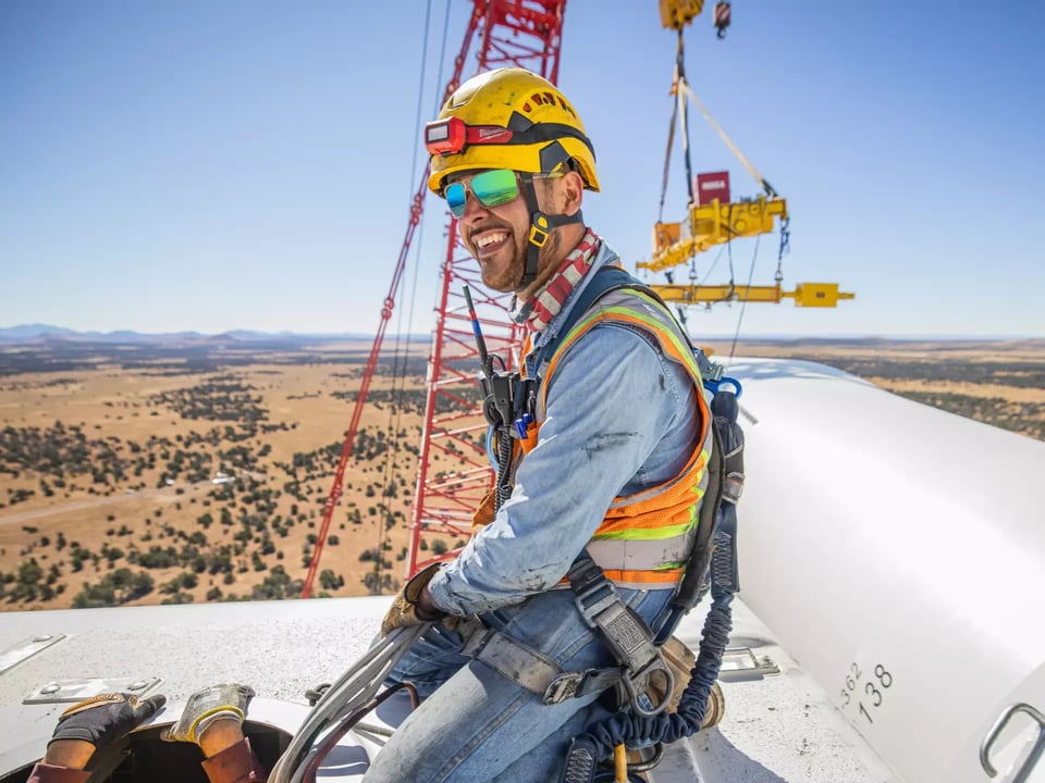 Team atop wind turbine during construction