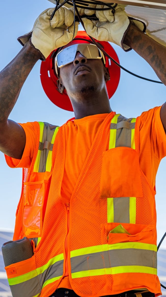 Close up of field worker installing solar panels