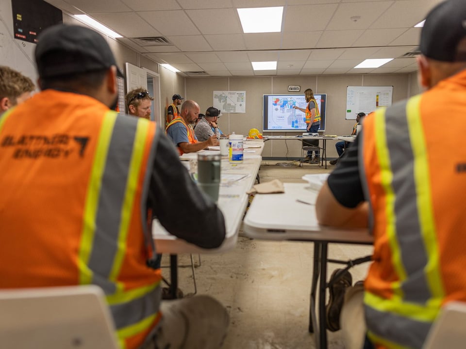 Teammate draws on tv during morning project meeting