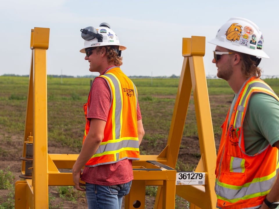 Two project site teammates in the field