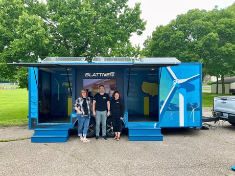 Blattner employees pose in front of the community trailer during educational event.